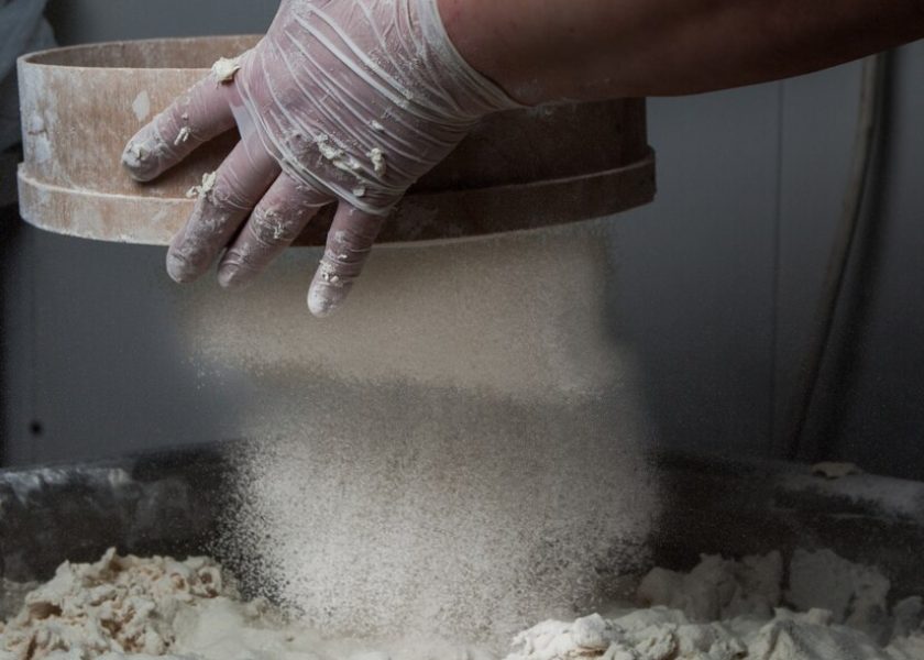 side-view-dough-with-flour-sieve-human-hand_176474-3069